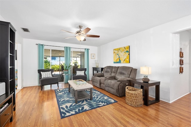 living room with wood-type flooring and ceiling fan