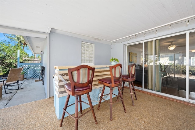 dining room featuring track lighting and bar area