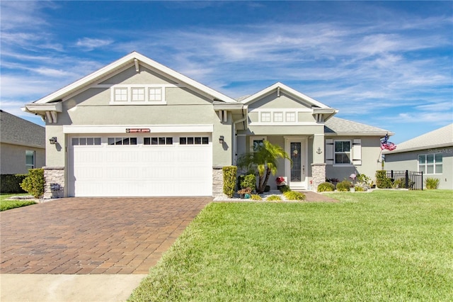 craftsman house featuring a front yard and a garage