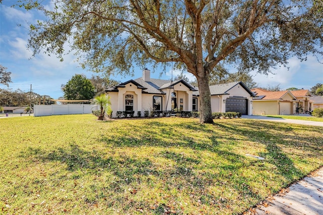 ranch-style home with a garage and a front lawn