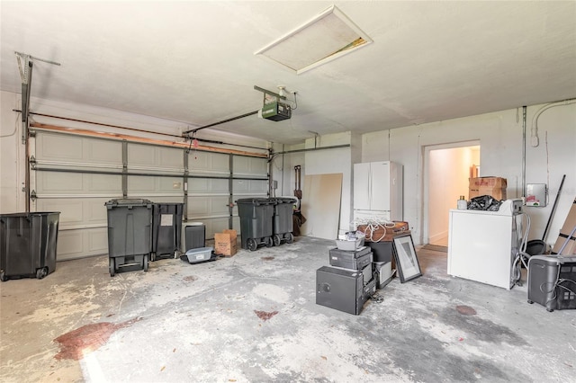 garage featuring washer / clothes dryer and a garage door opener