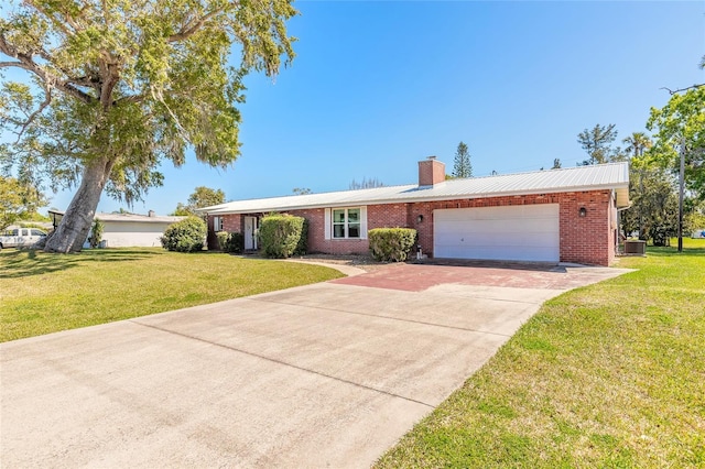 ranch-style house with a garage, brick siding, concrete driveway, and a front lawn