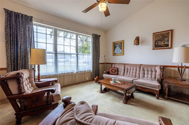 carpeted living area with ceiling fan and vaulted ceiling