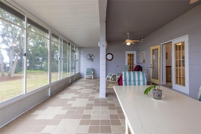 unfurnished sunroom with ceiling fan