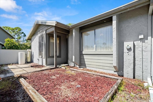 exterior space with a patio area, stucco siding, and fence