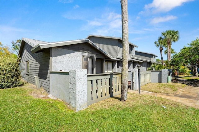 view of property exterior featuring a yard and stucco siding