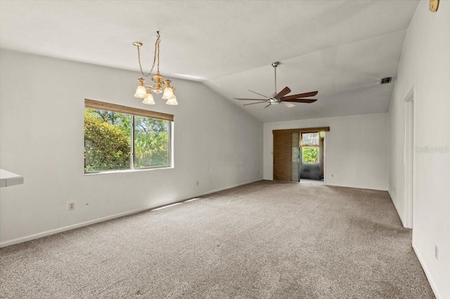 carpeted empty room with visible vents, ceiling fan with notable chandelier, baseboards, and vaulted ceiling