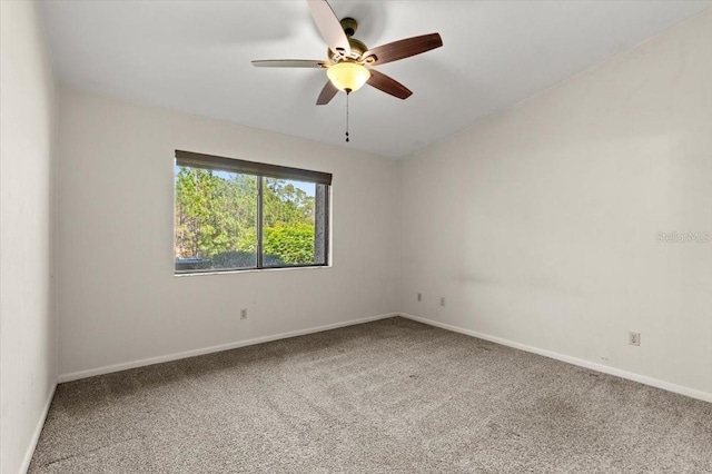 carpeted empty room featuring baseboards and ceiling fan