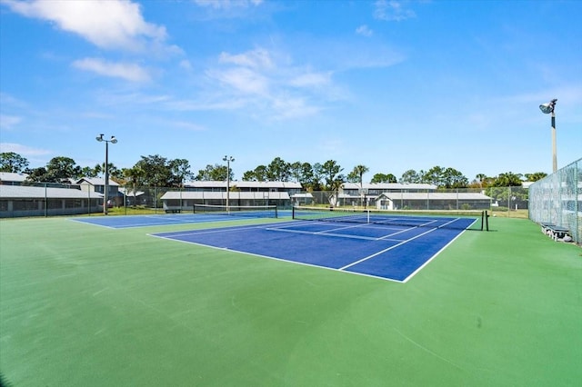 view of tennis court with fence