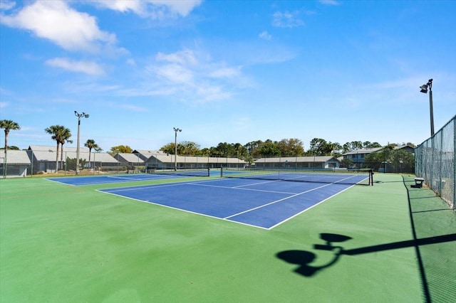 view of sport court featuring fence