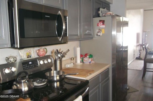 kitchen featuring appliances with stainless steel finishes and gray cabinetry