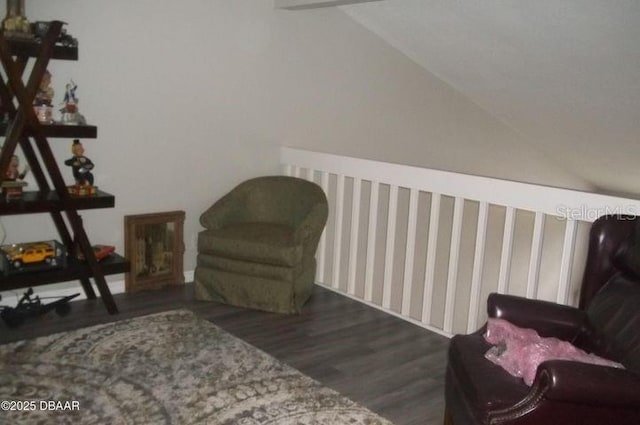 sitting room with dark hardwood / wood-style flooring and vaulted ceiling