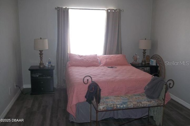 bedroom with dark hardwood / wood-style flooring