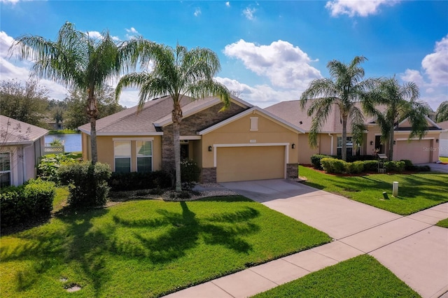 view of front facade with a water view, a garage, and a front lawn