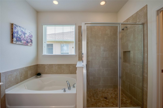 bathroom with shower with separate bathtub