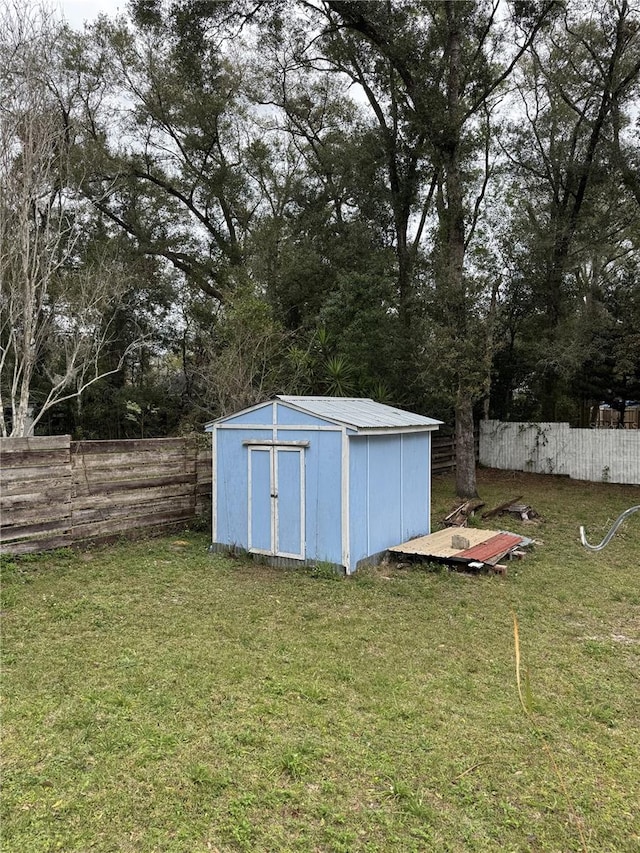 view of outdoor structure featuring a lawn