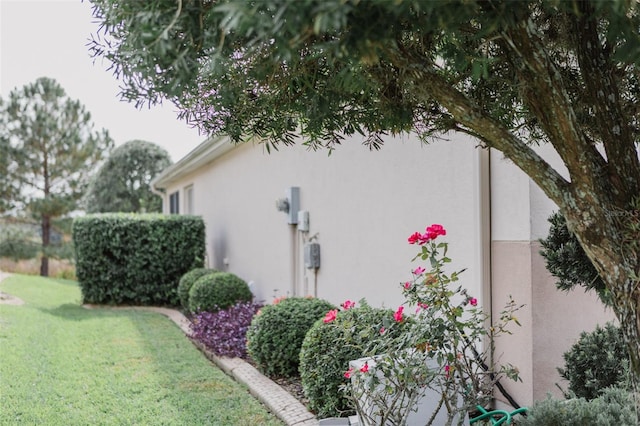 view of side of property with a lawn