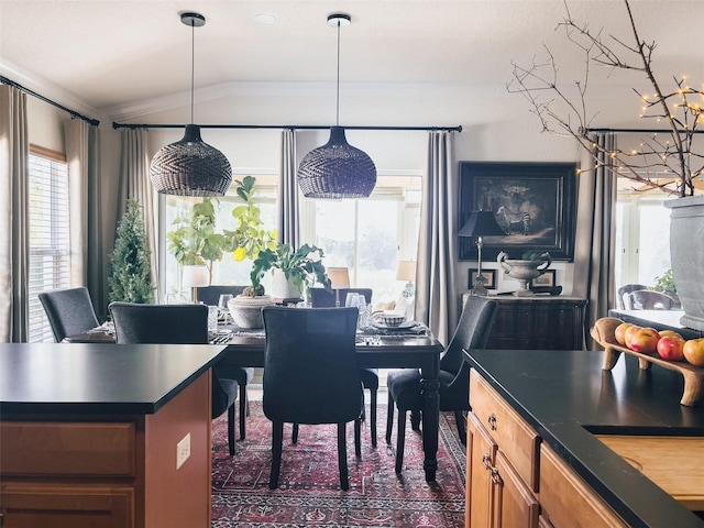 dining room featuring ornamental molding and vaulted ceiling