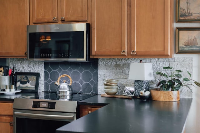 kitchen with decorative backsplash and appliances with stainless steel finishes