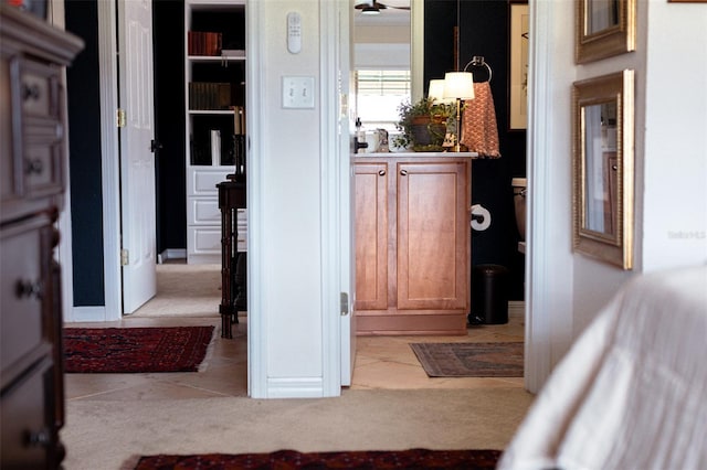 hall featuring light colored carpet