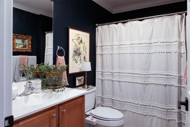 bathroom featuring vanity, ornamental molding, and toilet