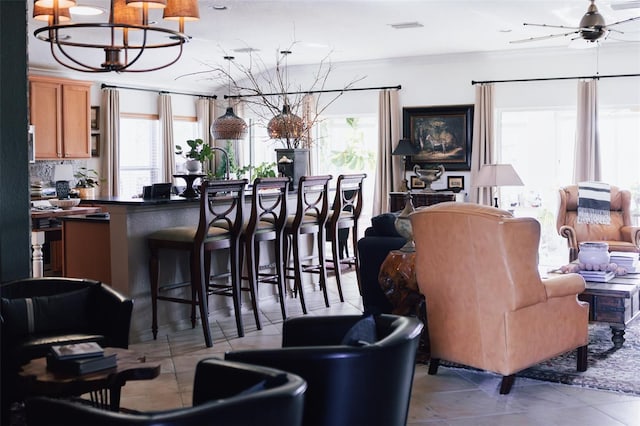 interior space with ceiling fan with notable chandelier