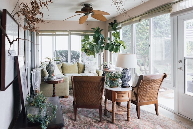 sunroom / solarium with a healthy amount of sunlight and ceiling fan