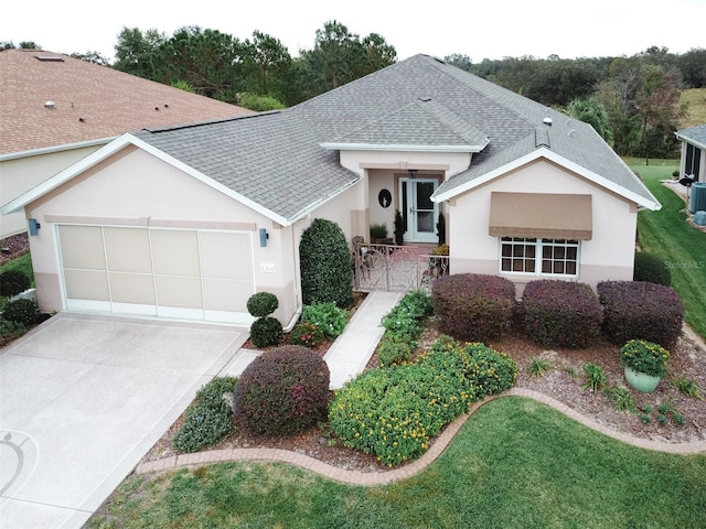 single story home with a garage and a front lawn