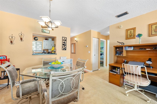 carpeted dining area with a textured ceiling