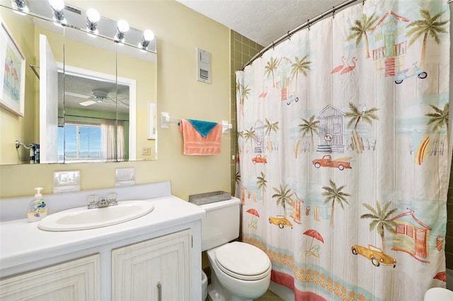 bathroom featuring a textured ceiling, vanity, curtained shower, and toilet