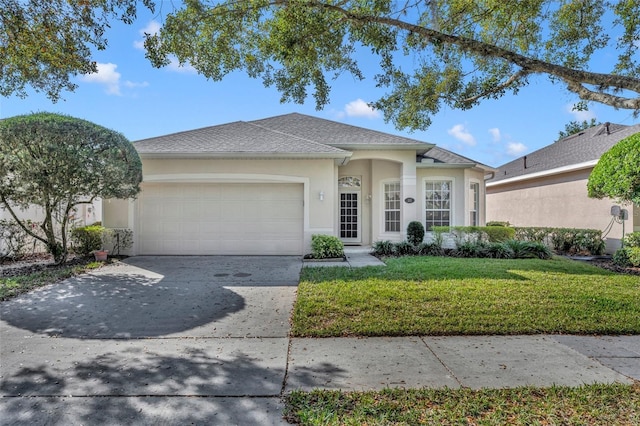 ranch-style house featuring a garage and a front yard