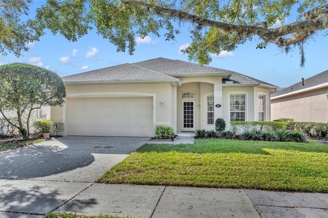 view of front facade with a garage and a front lawn