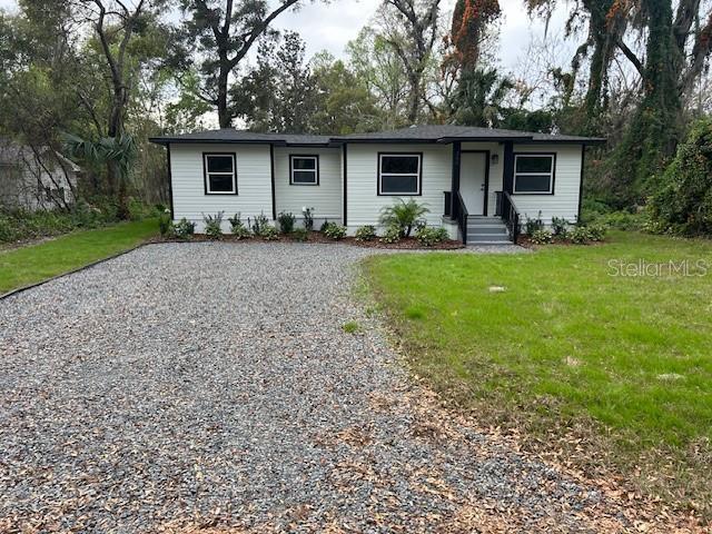 ranch-style home with a front yard