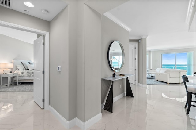 corridor featuring marble finish floor, visible vents, and baseboards