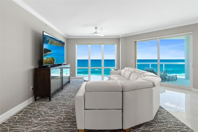 living area featuring baseboards, ornamental molding, and a ceiling fan