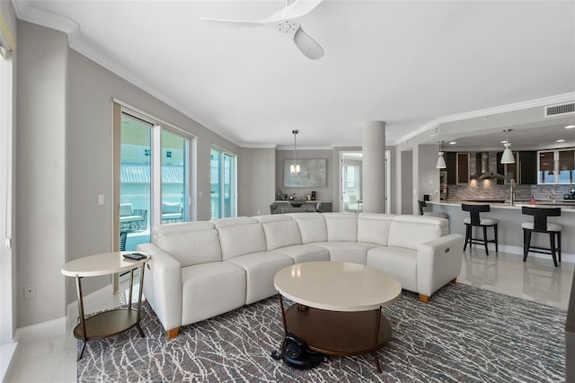 living area featuring a ceiling fan, baseboards, visible vents, marble finish floor, and crown molding