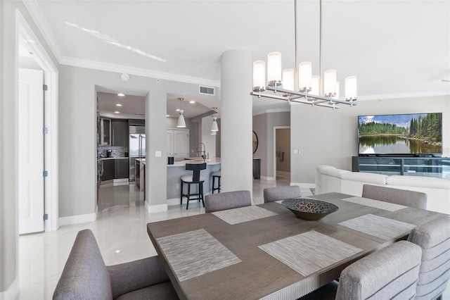 dining space featuring a notable chandelier, baseboards, visible vents, and crown molding