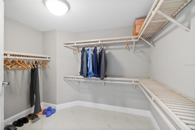 spacious closet with marble finish floor