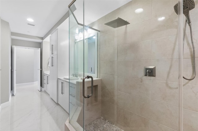 bathroom with marble finish floor, a stall shower, vanity, and recessed lighting