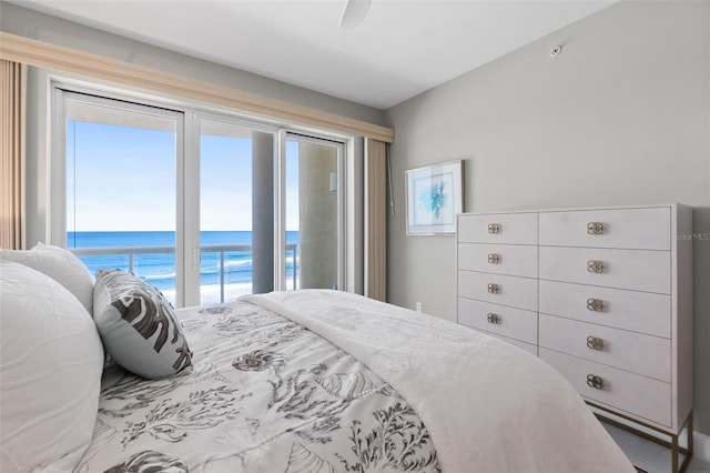 bedroom featuring a water view, access to exterior, and ceiling fan