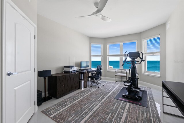 office space featuring a ceiling fan, visible vents, and baseboards