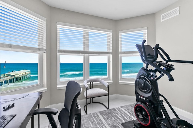 office featuring visible vents, plenty of natural light, and a water view