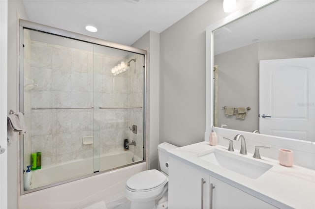 full bathroom with toilet, enclosed tub / shower combo, and vanity