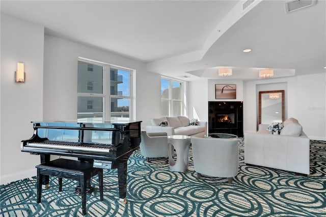 living area with visible vents, baseboards, and a tile fireplace