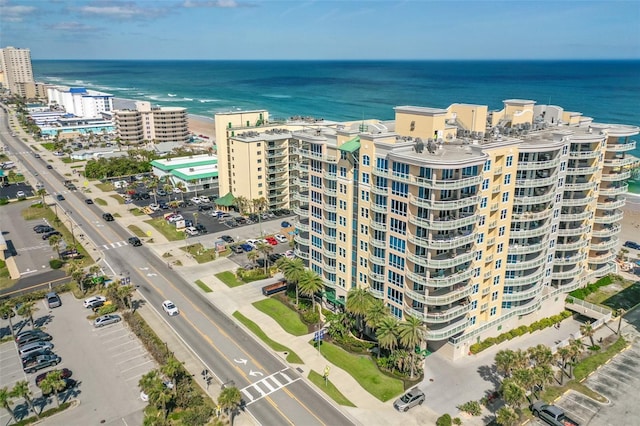 drone / aerial view featuring a water view and a view of city