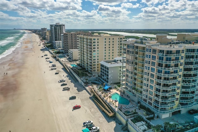 birds eye view of property with a water view, a view of city, and a view of the beach