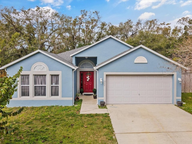 single story home featuring a garage, driveway, a front yard, and stucco siding