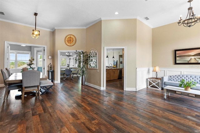 dining area featuring a chandelier, dark hardwood / wood-style flooring, plenty of natural light, and ornamental molding