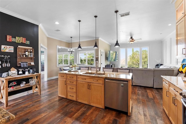 kitchen with a center island with sink, sink, light stone counters, pendant lighting, and stainless steel appliances