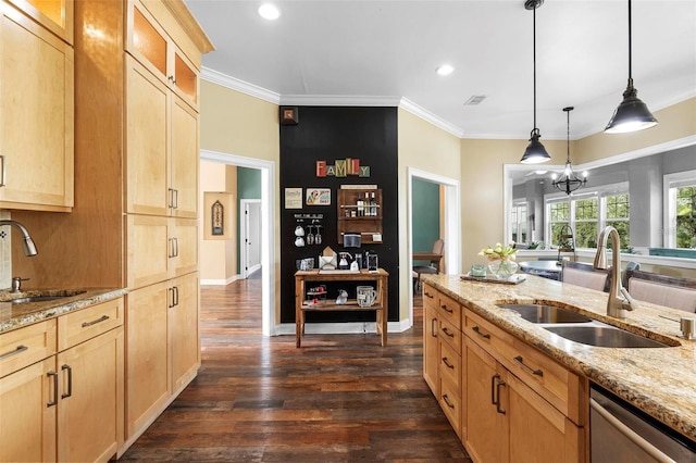 kitchen with sink, light stone countertops, hanging light fixtures, and dishwasher